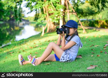 photographer little girl takes a photo on the garden