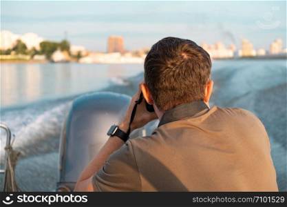 photographer photographs of the city from a boat. photographer photographs of the city from a boat.