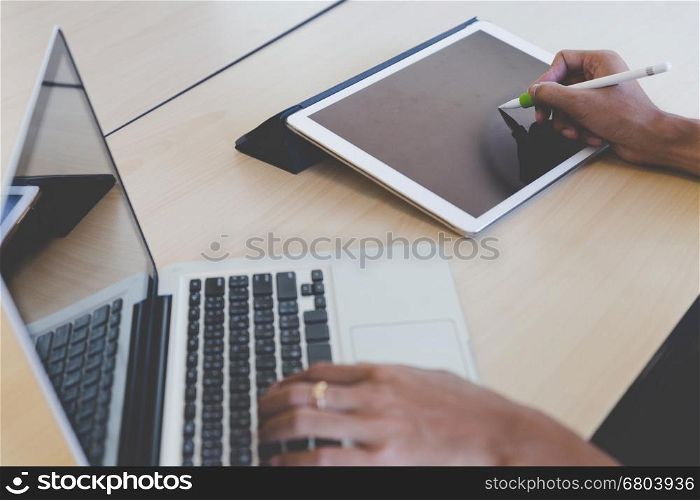 photographer retouching photo, graphic designer drawing image using a digital tablet, pen and computer laptop