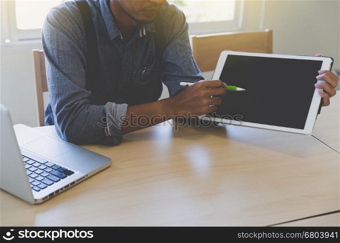 photographer retouching photo, graphic designer drawing image using a digital tablet, pen and computer laptop