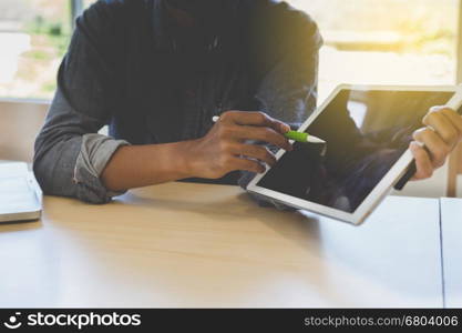 photographer retouching photo, graphic designer drawing image using a digital tablet, pen and computer laptop