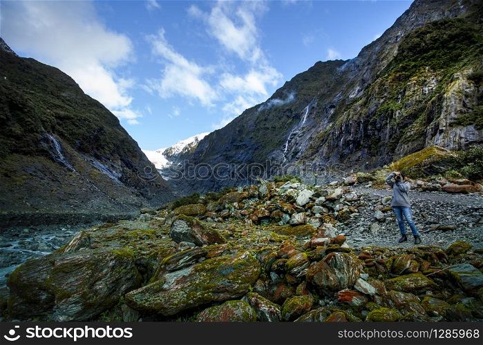 photographer taking a photograph in franz josef glacier one of most popular traveling destination in west coast southland new zealand