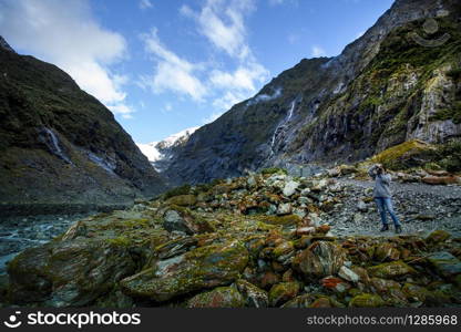 photographer taking a photograph in franz josef glacier one of most popular traveling destination in west coast southland new zealand