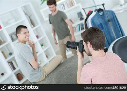 photographer taking a picture of two young models