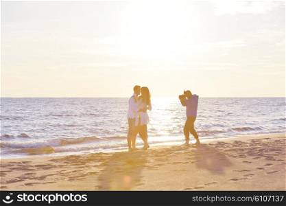 photographer taking photo of models couple on beautiful tropical beach at summer