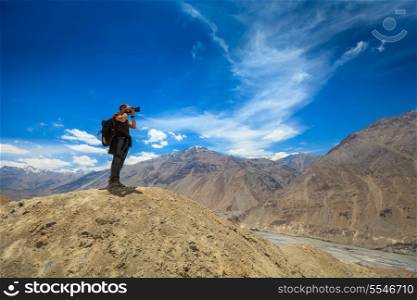 Photographer taking photos in Himalayas mountains. Spiti valley, Himachal Pradesh, India