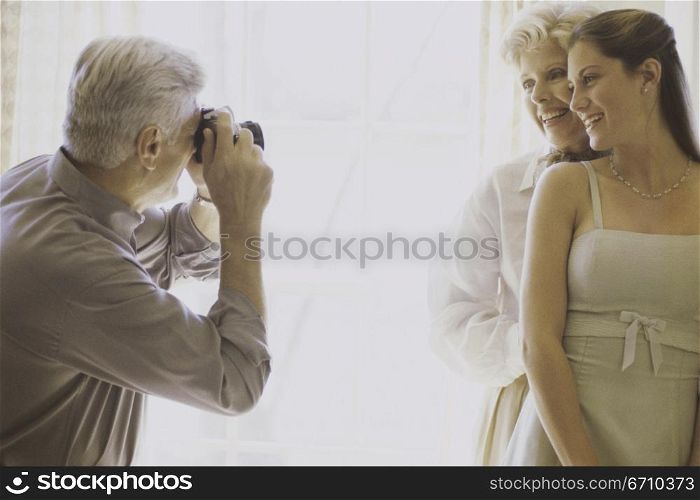 Photographer talking a snapshot of a mother and daughter