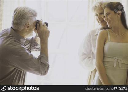 Photographer talking a snapshot of a mother and daughter