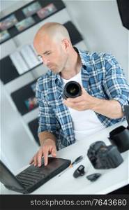 photographer with modern digital dslr camera and laptop