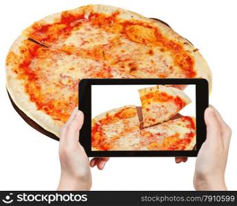 photographing food concept - tourist takes picture of italian pizza Margherita on smartphone, Italy