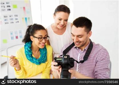 photography and creative people concept - photographers with camera at photo studio. photographers with camera at photo studio