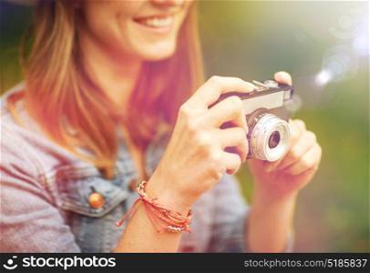 photography and people concept - close up of young woman with film camera photographing outdoors. close up of woman with camera shooting outdoors
