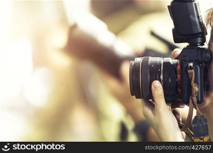 Photography concept. Closeup of lens while photographer shooting outdoor with blurred background. Picture for add text message. Backdrop for design art work.