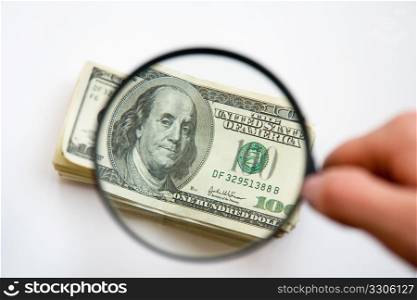 photography of the dollars with magnifying glass
