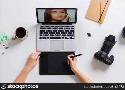 photography, people and design concept - hands with graphic tablet retouching photo on laptop computer and camera at table. woman with camera working on laptop at table