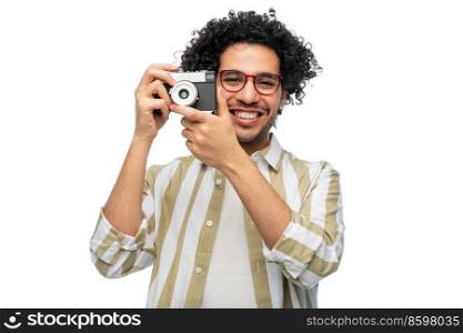 photography, profession and people and concept - happy smiling man or photographer in glasses with film camera over white background. smiling man or photographer with film camera