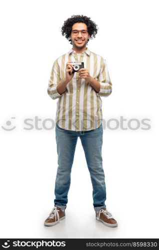 photography, profession and people and concept - happy smiling man or photographer in glasses with film camera over white background. smiling man or photographer with film camera