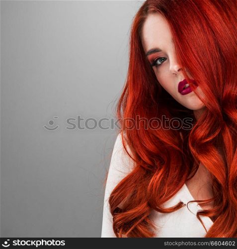 Photoshot of gorgeous redhead girl with bright makeup. Gorgeous redhead girl