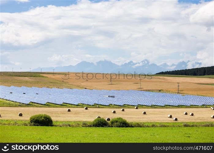 Photovoltaic modules at the yellow field. Countryside landscape and green ecology alternative power farm