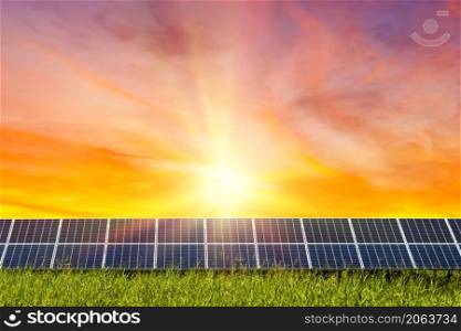 Photovoltaic modules solar power plant on dramatic sunset sky background,clean Alternative power energy concept.