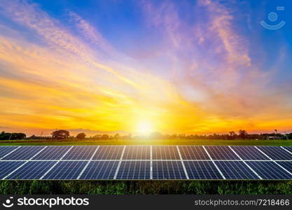 Photovoltaic modules solar power plant on dramatic sunset sky background,clean Alternative power energy concept.