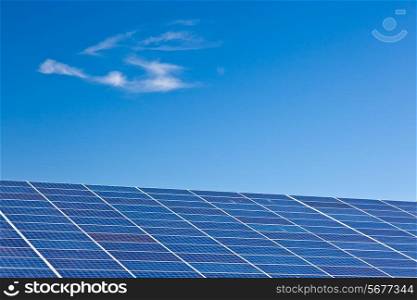 Photovoltaic panels. Photovoltaic panels in a solar power plant over a deep blue sky.