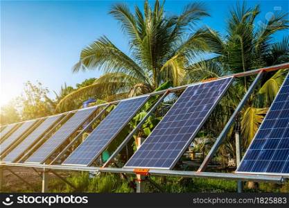 photovoltaic solar power panel for agriculture in a rural houses area Agricultural fields blue sky background,Agro-industry of household Rural style in Thailand, smart farm alternative clean energy.