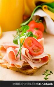 phto of delicious toast with ham on wooden table with orange juice
