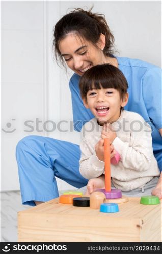 Physical therapist playing with a boy who has cerebral palsy. High quality photo.. Physical therapist playing with a boy who has cerebral palsy.