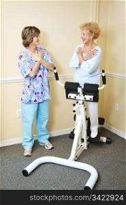 Physical therapist working with a chiropractic patient to improve her spine flexibility.