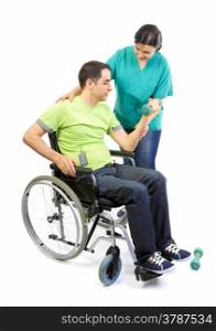 Physical therapist works with patient in lifting hands weights. Young adult in wheelchair.