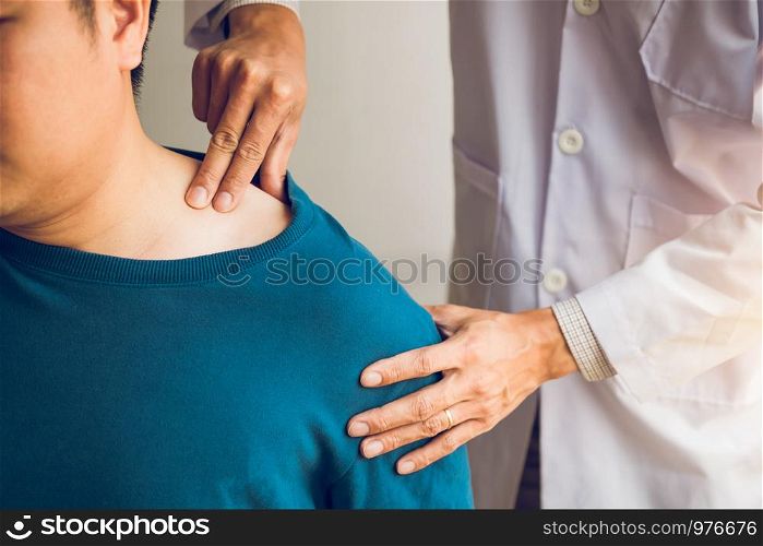 Physical therapists are using their hands to press the clavicle of the patient.