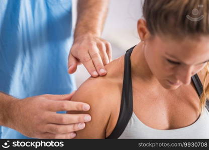 Physical therapy. Therapist addressing trapezius muscle