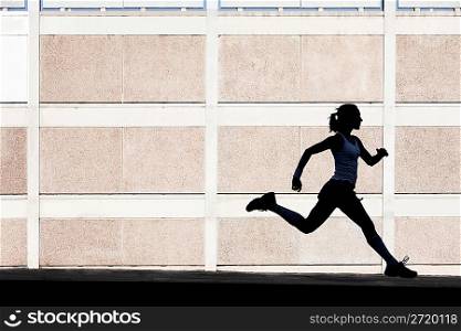 Physically fit woman runs for exercise