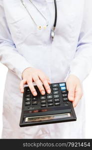 physician calculates the cost of treatment on calculator