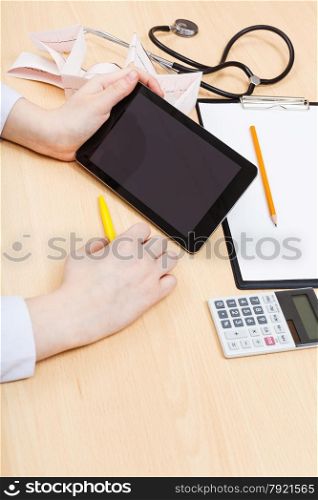 physician calculates with tablet pc during appointment