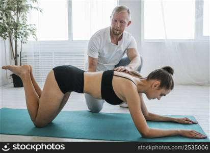 physician during physiotherapy session with woman