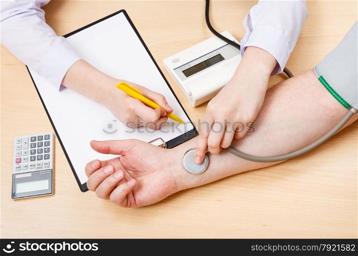 physician makes appointment and measures blood pulse of patient