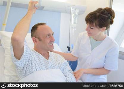 physician with her patient recovering in bed