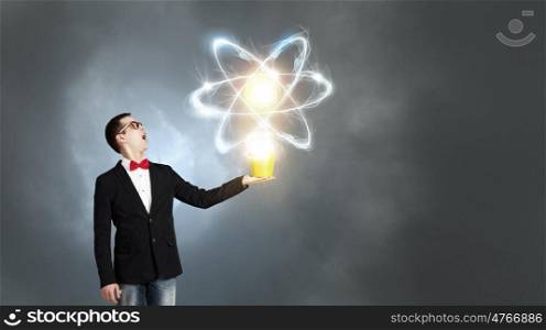 Physics science concept. Young man in black jacket with yellow bucket in hand