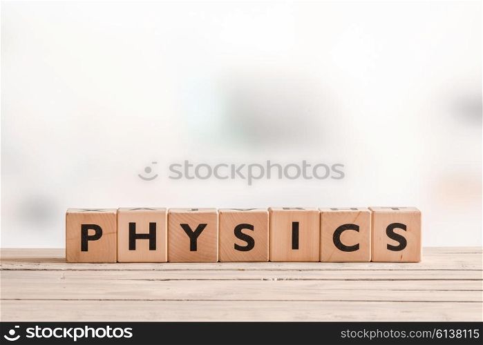 Physics sign made of solid cubes on a desk