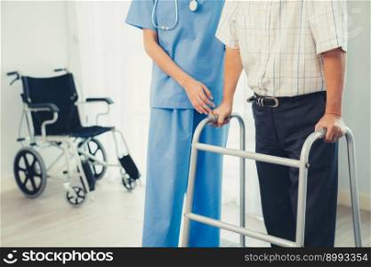 Physiotherapist assists contented senior man on folding walker. Recuperation for elderly, seniors care, nursing home.. Physiotherapist assists her contented senior patient on folding walker.