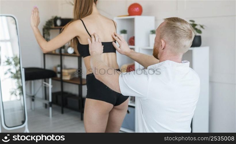 physiotherapist checking woman s balance