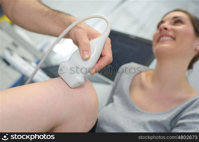 physiotherapist doctor performs treatment on a patients leg