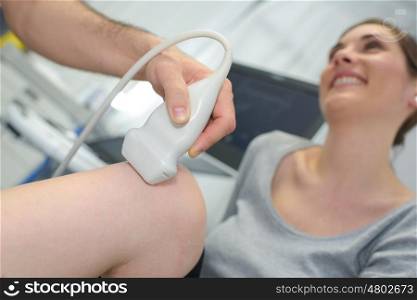 physiotherapist doctor performs treatment on a patients leg