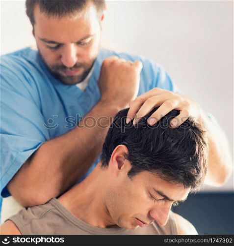 Physiotherapist doing healing treatment on man&rsquo;s neck, Therapist wearing blue uniform, Osteopath,  Chiropractic adjustment, pain relief concept