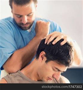 Physiotherapist doing healing treatment on man&rsquo;s neck, Therapist wearing blue uniform, Osteopath,  Chiropractic adjustment, pain relief concept