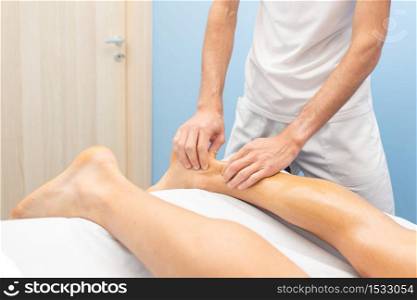 Physiotherapist during an Achilles tendon treatment.