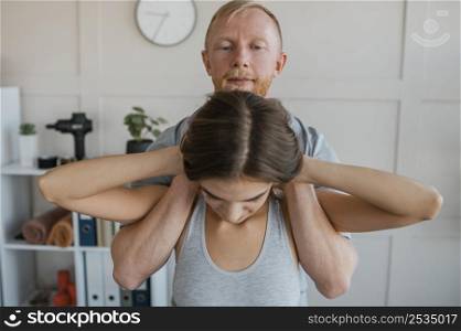physiotherapist during therapy session with female patient