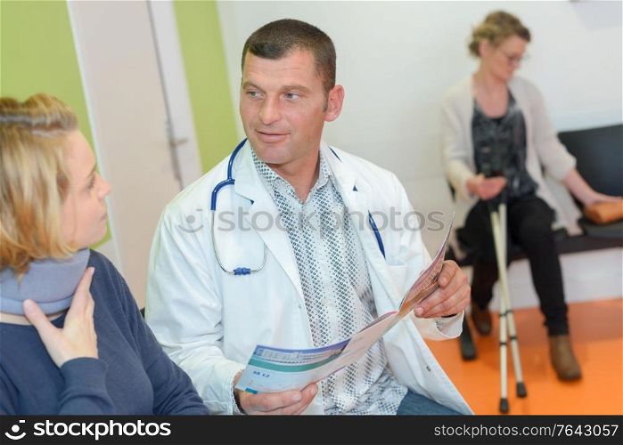 physiotherapist examining a patients neck in the clinic